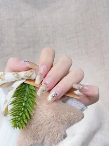 Detail of long coffin press-on nails with 3D butterfly, rhinestones and gold glitter