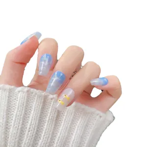 Blue glitter gradient press-on nails with cute yellow duck patterns on short coffin shape