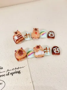 Detail of 3D embossed capybara press-on nails with hand-painted patterns for kids