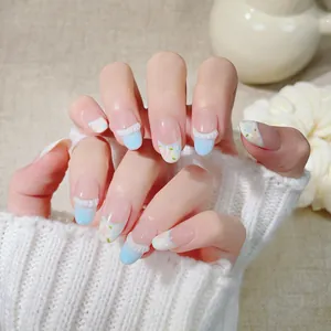 Handmade light blue French press-on nails with floral patterns and 3D white ruffle lace
