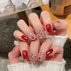Handmade short red cat-eye press-on nails with glitter stars and heart dot patterns