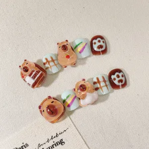 Handmade 3D capybara press-on nails for kids with cute rainbow and grid patterns