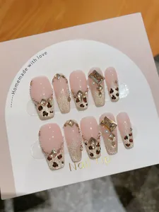 Detail of handmade press-on nails featuring leopard print, cat eye glitter, and gold crystals