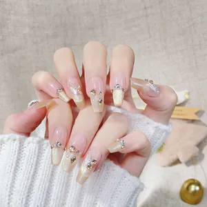 French champagne gold glitter press-on nails with 3D butterflies, rhinestones, and pearls