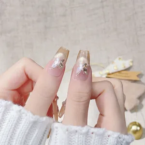 Champagne cat eye press-on nails with 3D butterfly and pearl accents for luxury style
