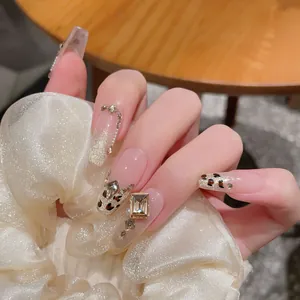 Handmade leopard print press-on nails with luxury crystals and gold glitter gradient