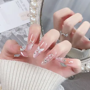 Handmade gradient blush press-on nails with 3D butterfly charms and crystal accents