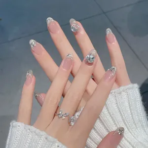Cat-eye nude pink press-on nails with silver glitter, pearls and rhinestone accents