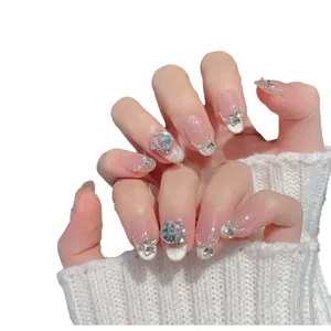 Handmade light pink gradient press-on nails with pearls, crystals and metal bows