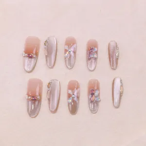 Handmade cat eye press-on nails with 3D butterflies and crystals on nude pink gradient