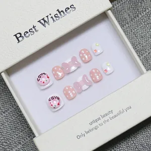 Pink and white handmade toe press-on nails with 3D donuts and cute bow designs