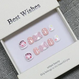 Handmade 3D cartoon press-on nails for kids featuring pink donuts and bows in a gift box