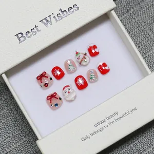 Handmade Christmas press-on nail set with 3D Santa and snowman designs in a gift box