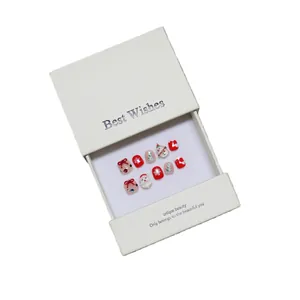 Handmade Christmas press-on nails set with 3D Santa and snowflake patterns in festive red