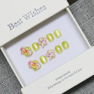 Kids yellow glitter press-on nails with 3D seahorse and star charms in a gift box