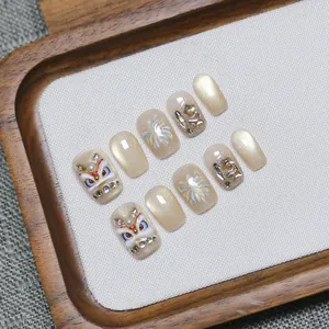Handmade press-on nails set featuring 3D lion dance art and golden cat eye finish