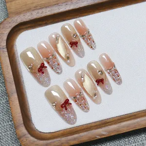 Handmade press-on nails with brown bow, cat-eye finish, and elegant tweed pattern