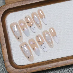 Handmade almond press-on nails with nude white gradient, silver bows and rhinestones