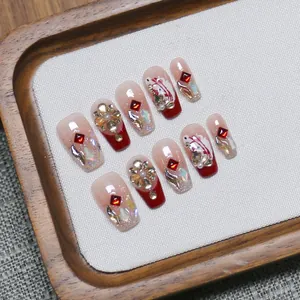 Handmade red gradient koi press-on nails with luxury gems and gold floral accents