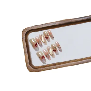 Handmade gradient brown press-on nails with red bow, pearls and tweed texture patterns
