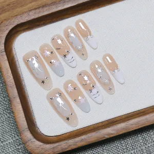 Long almond press-on nails with pink French tips, silver stars and rhinestones