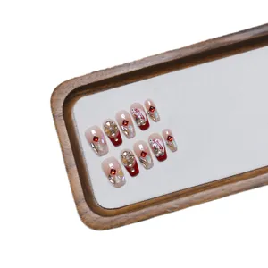 Handmade red and pink gradient press-on nails with luxury rhinestones and floral art