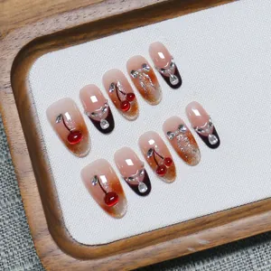 Handmade cherry cat eye press-on nails with French gradient and 3D rhinestone bow