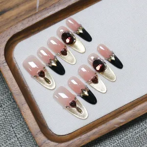 Handmade brown cat-eye press-on nails with pink gradient and gold glitter accents