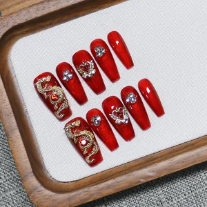 Handmade red press-on nails with golden dragon relief and rhinestones for New Year