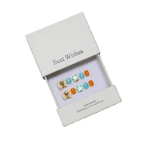 Faux ongles faits main pour enfants avec nœuds colorés et strass dans une boîte cadeau