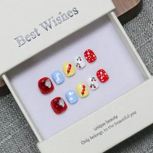 Handmade cute cartoon press-on nails for kids with apple and cherry designs in a gift box