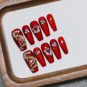 Red handmade press-on nails with golden dragon and rhinestone coffin shape designs