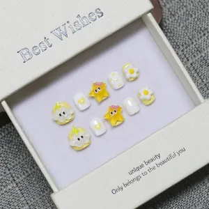 Cartoon press-on nails for kids with yellow starfish and heart designs in gift box
