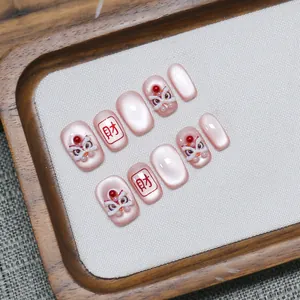 Pink cat-eye press-on nails with 3D lion dance motifs and lucky Chinese character art