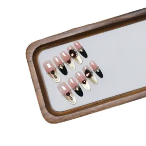 Handmade press-on nails with pink gradient and black cat-eye design featuring red heart jewels
