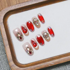 Handmade red cat eye press-on nails with 3D metal butterflies and rhinestones