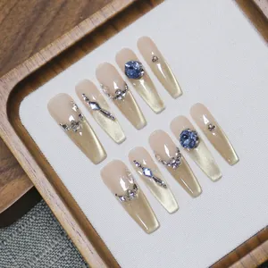 Luxurious French cat-eye press-on nails with blue gems and gold magnetic gradient