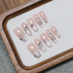 Handmade press-on nails featuring pink cat-eye gradient design with butterfly and rhinestones