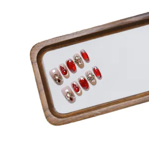 Handmade red cat eye press-on nails with 3D snowman and gold floral rhinestone accents