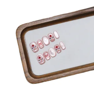 Pink cat eye press-on nails featuring 3D lion dance relief and wealth character design