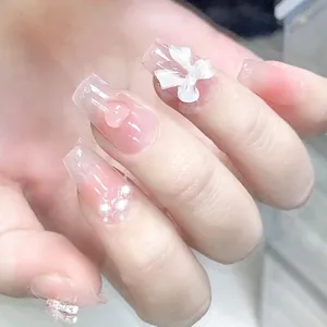 Handmade gradient pink press-on nails with 3D bows, pearls and heart charms