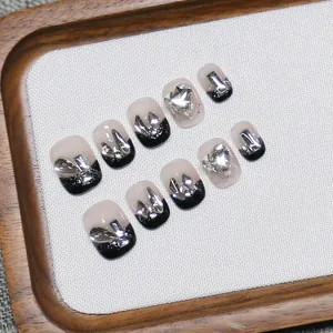 Handmade gradient press-on nails with black French tips, glitter, and silver heart charms