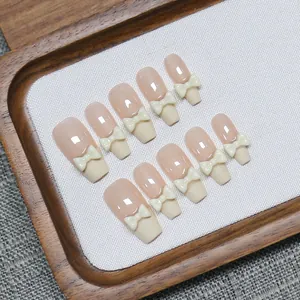 Handmade milky white bow French press-on nails set with elegant medium trapezoid shape