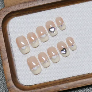 Handmade French press-on nails with white 3D hearts, pearls, and cream tips on nude pink base