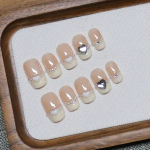 Handmade French nude press-on nails with cream tips, pearls and 3D heart charms
