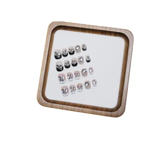 Handmade press-on nail kit with silver glitter gradients and black French heart rhinestones