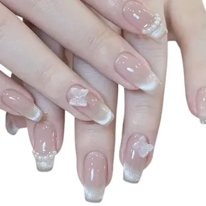 Handmade cat-eye press-on nails with 3D butterfly and pearl accents in pink gradient