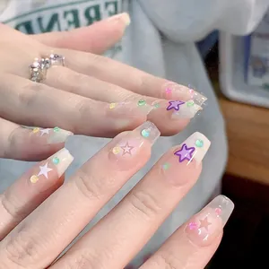 Handmade almond press-on nails with cute stars and colorful 3D beads on nude base