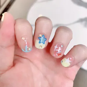 Cute star pattern press-on nails with blue stars and yellow tones for student style