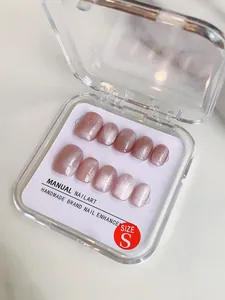 Macro shot of 10-piece pink cat eye handmade press-on nails in size S packaging